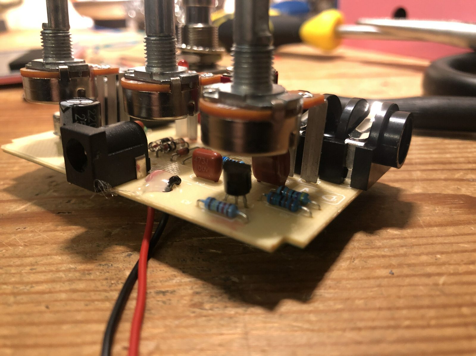 Close-up of a hand-built repair board, potentiometers and passives